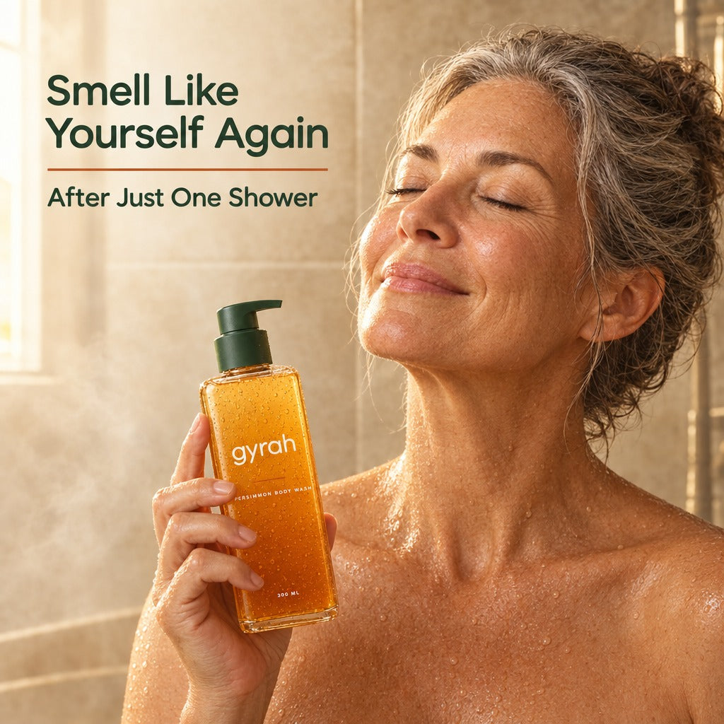 A woman in the shower holding Gyrah Persimmon Body Wash.